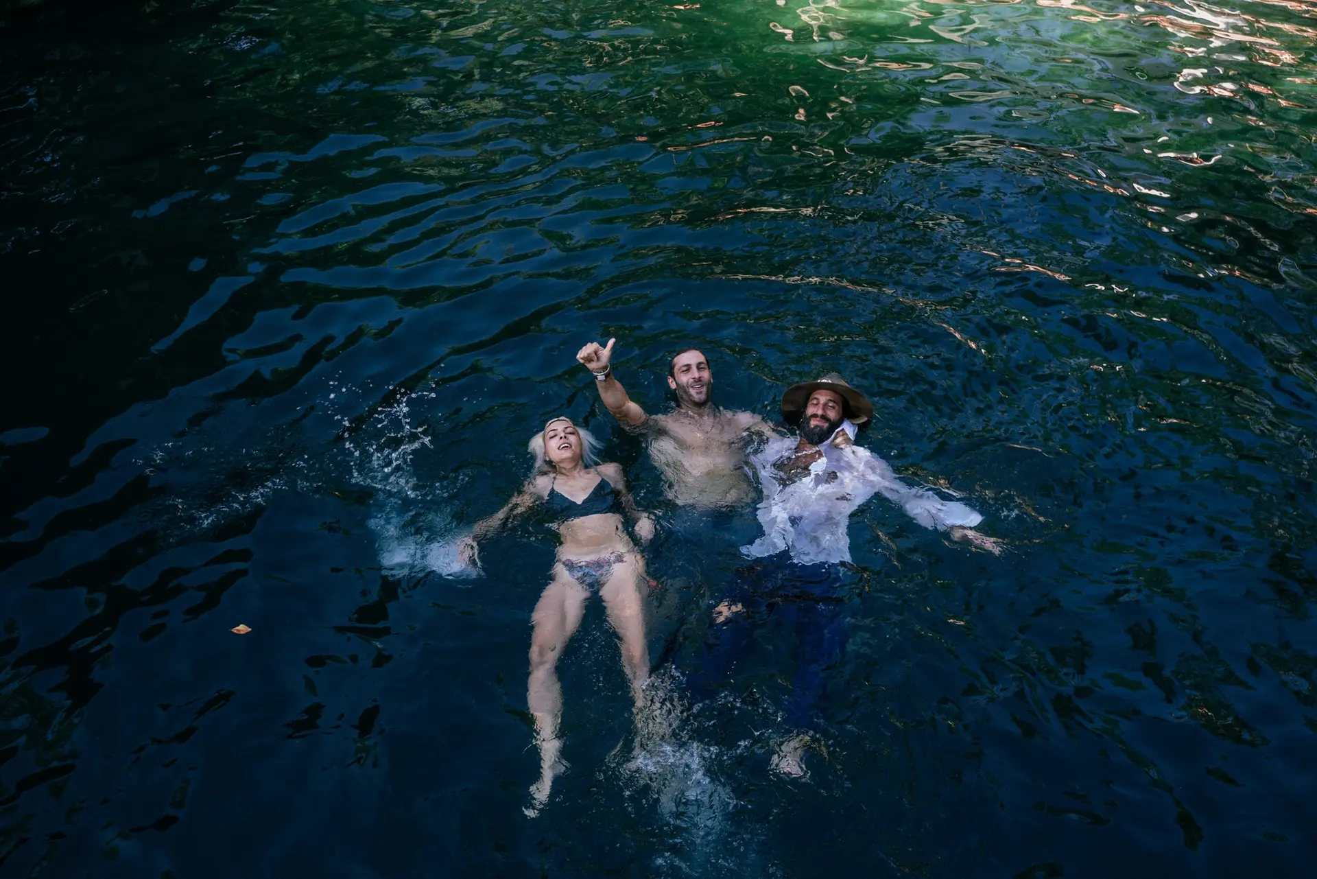 Festival attendees swimming together in a cenote