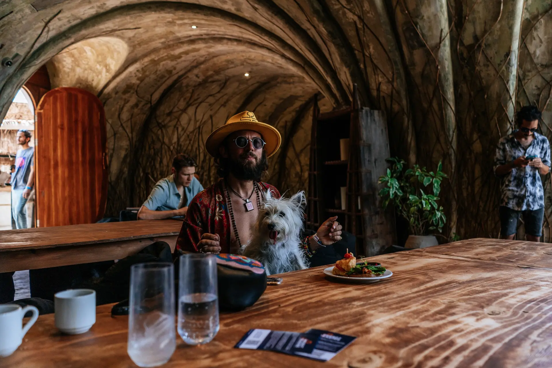 Festival attendee and dog gathered around a shared table
