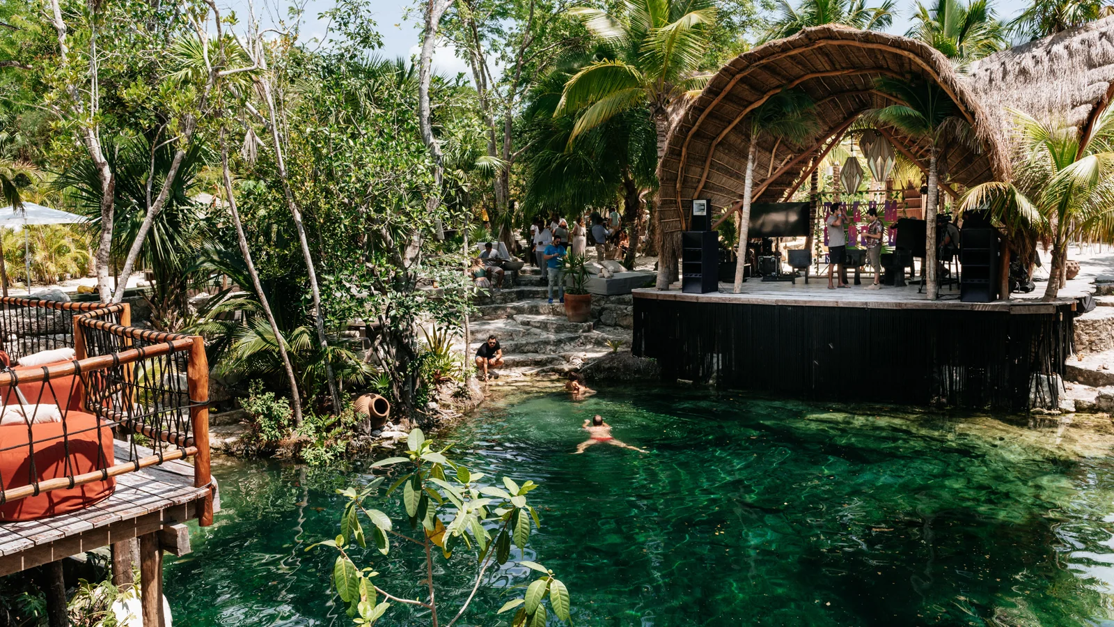 Wide view of the cenote stage and tropical venue